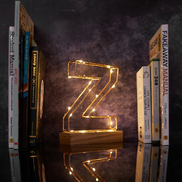 Illuminated letter Z on a bookshelf