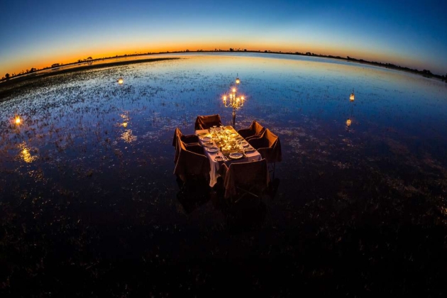 No people, dinner table set up in night in the wilderness