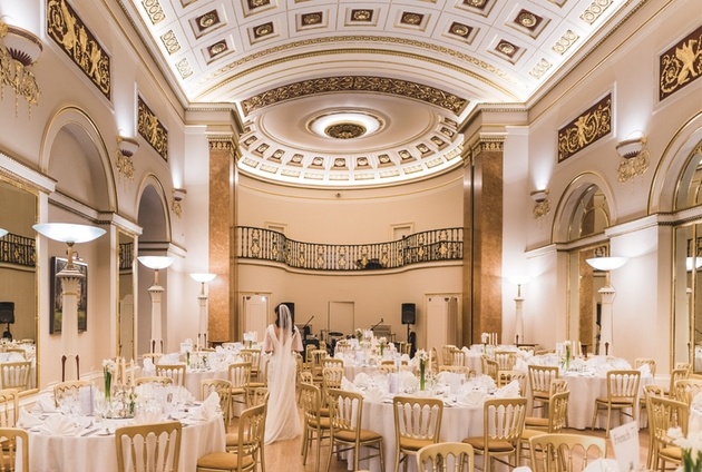Bride walking through the ballroom at the historic Lansdowne Club venue in Mayfair