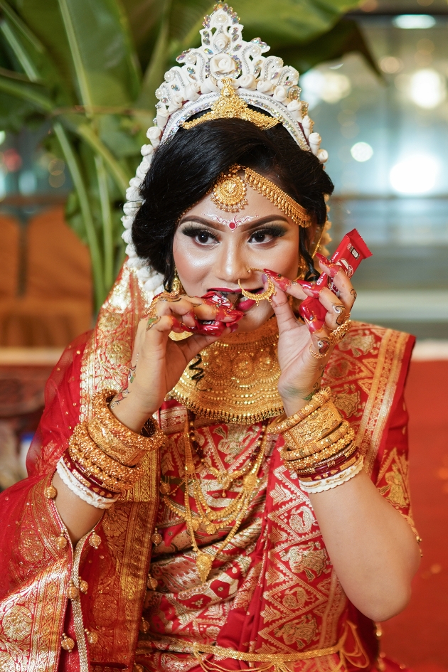 Bangladesh bride eating chocolate