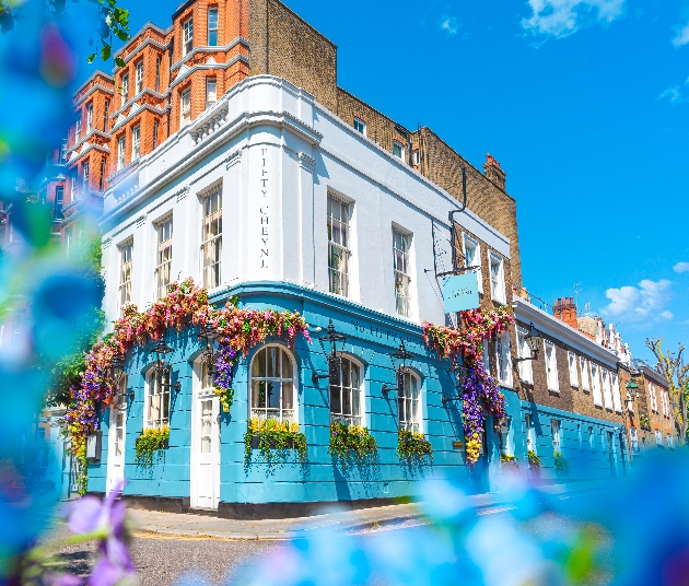 london venue with blue facade of bricks and flower baskets