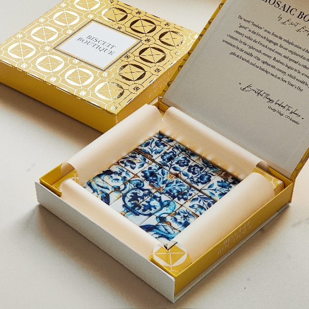 mosaic style picture biscuits in a gold box