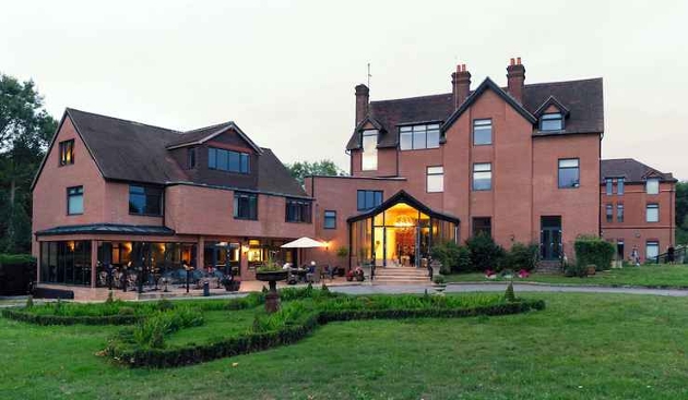 red brick venue with grounds  and terraced with tables and chairs