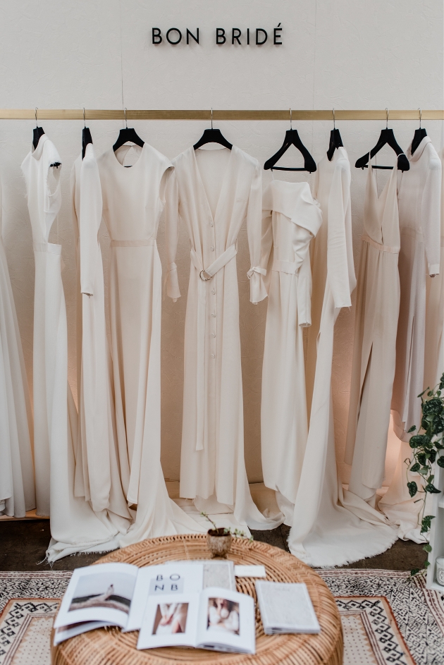 rack of dresses from Bon Bride in white tones