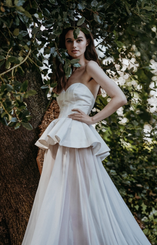 model in a strapless dress with corset silhouette over full skirt 