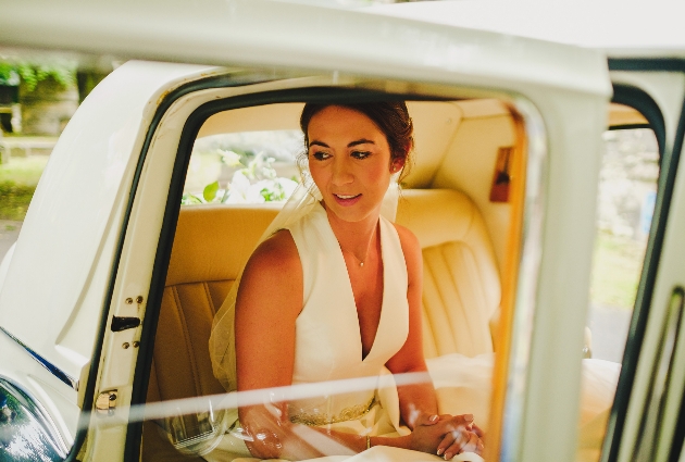 Bride sitting in wedding car