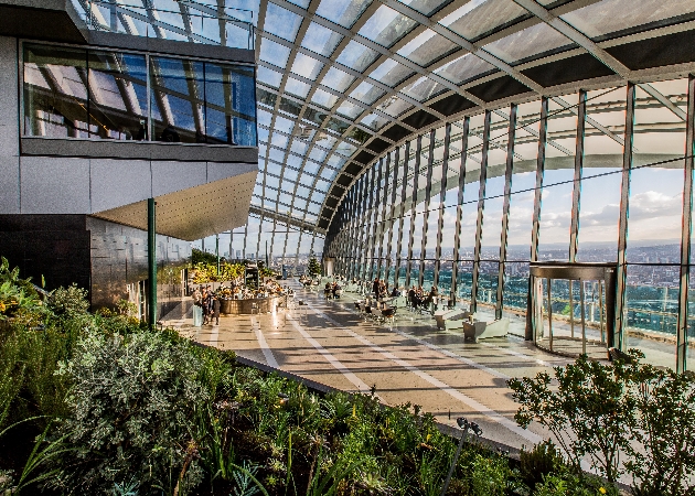 sky bar with glass roof lots of foliage views of the city