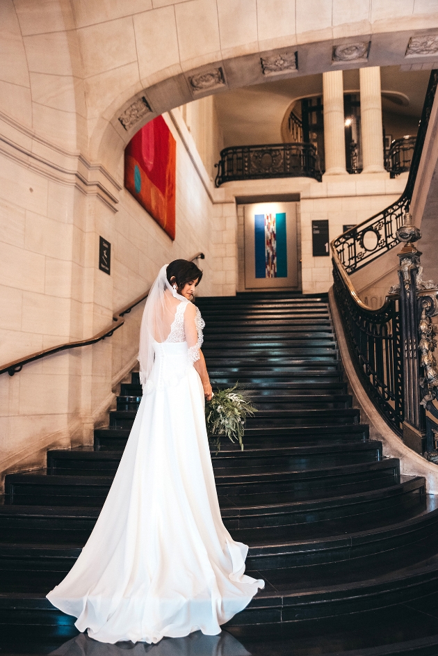 Bride's dress trailing down stairs