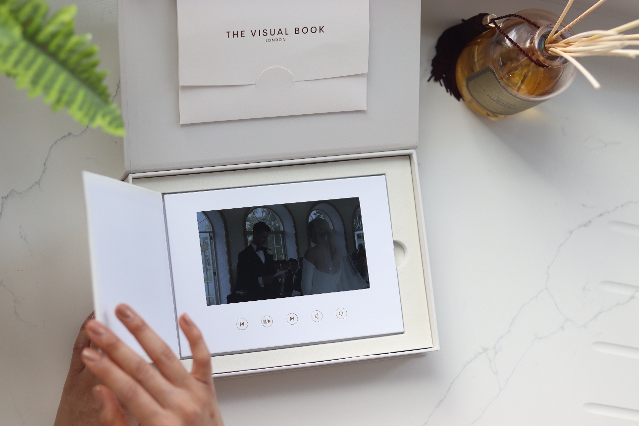 white linen album with a video player in it. 