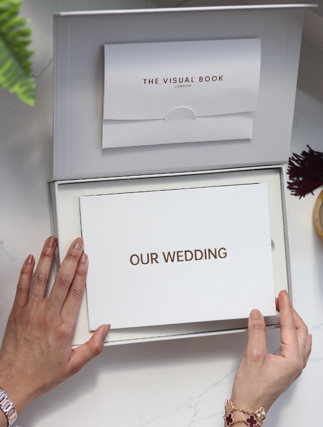 white wedding alum in a white box with our wedding in gold letter written on the front