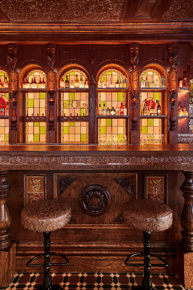 The Cadogan Arms wood panelled bar with stained glass backing 
