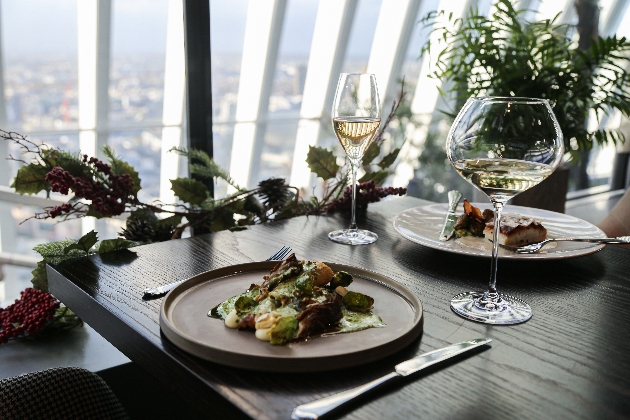 food on a plate on a table with views of london