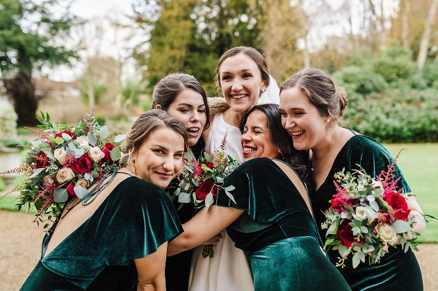 bride and her bridesmaids in green velvet dresses