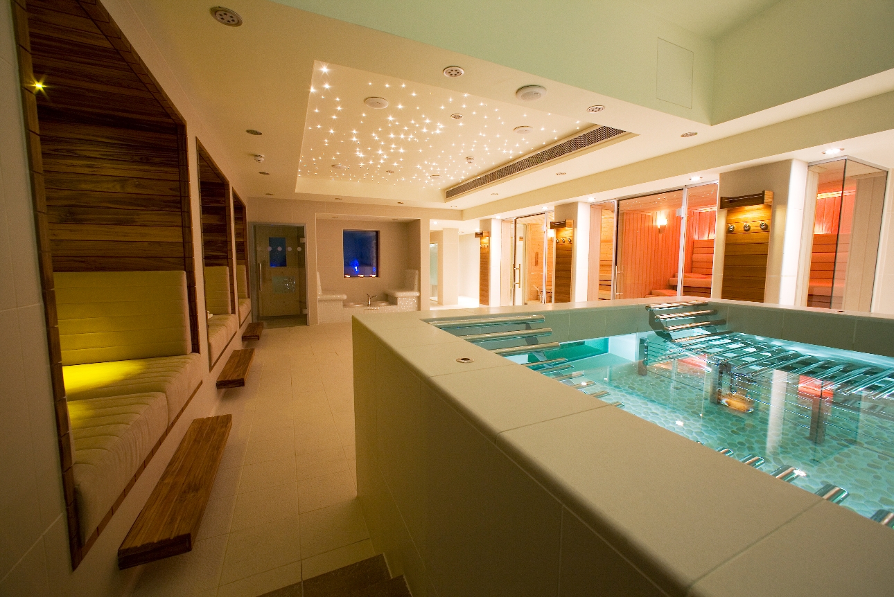 underground spa area with pool and seating areas