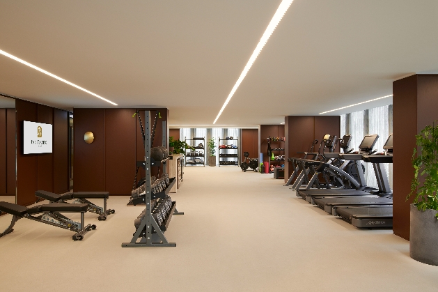 gym equipment in large space brown walls and cream floor