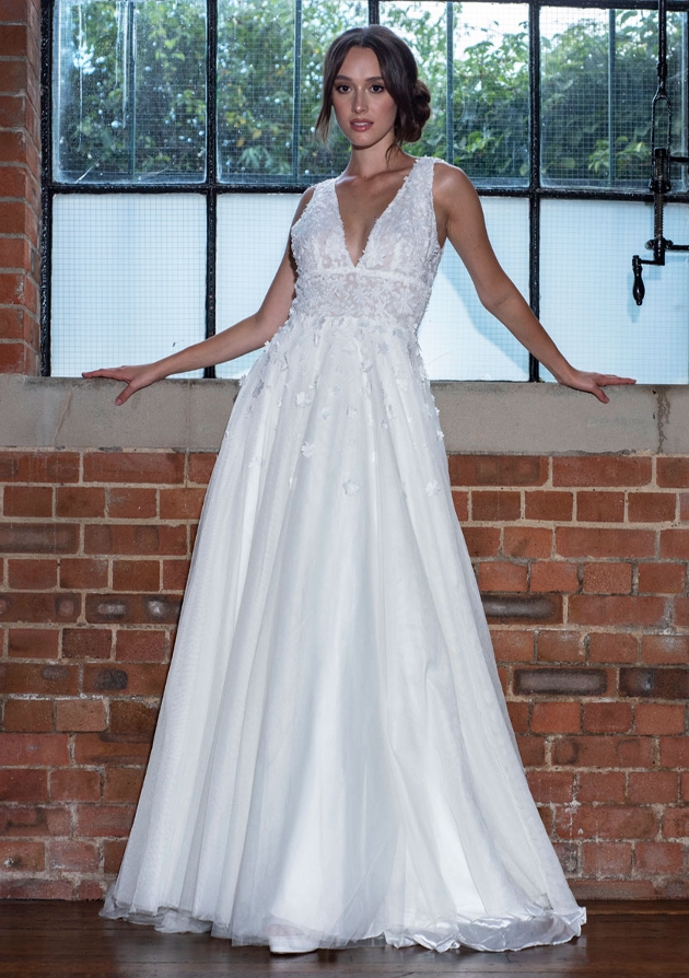 model in wedding dress low cut applique at top plain skirt 