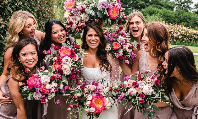 bride and bridesmaids holding colourful bouquets