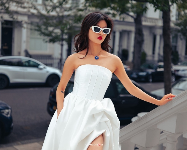 model in couture boned corset dress and wearing black and white sunglasses