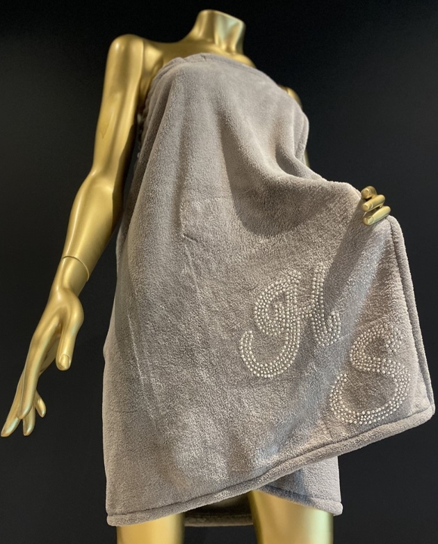 gold mannequin with grey towel on and pearl initials