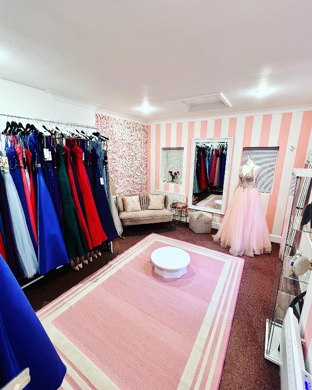 studio shop floor pink with rails of dresses and sofa