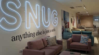 Sofas in room with snug sign. 