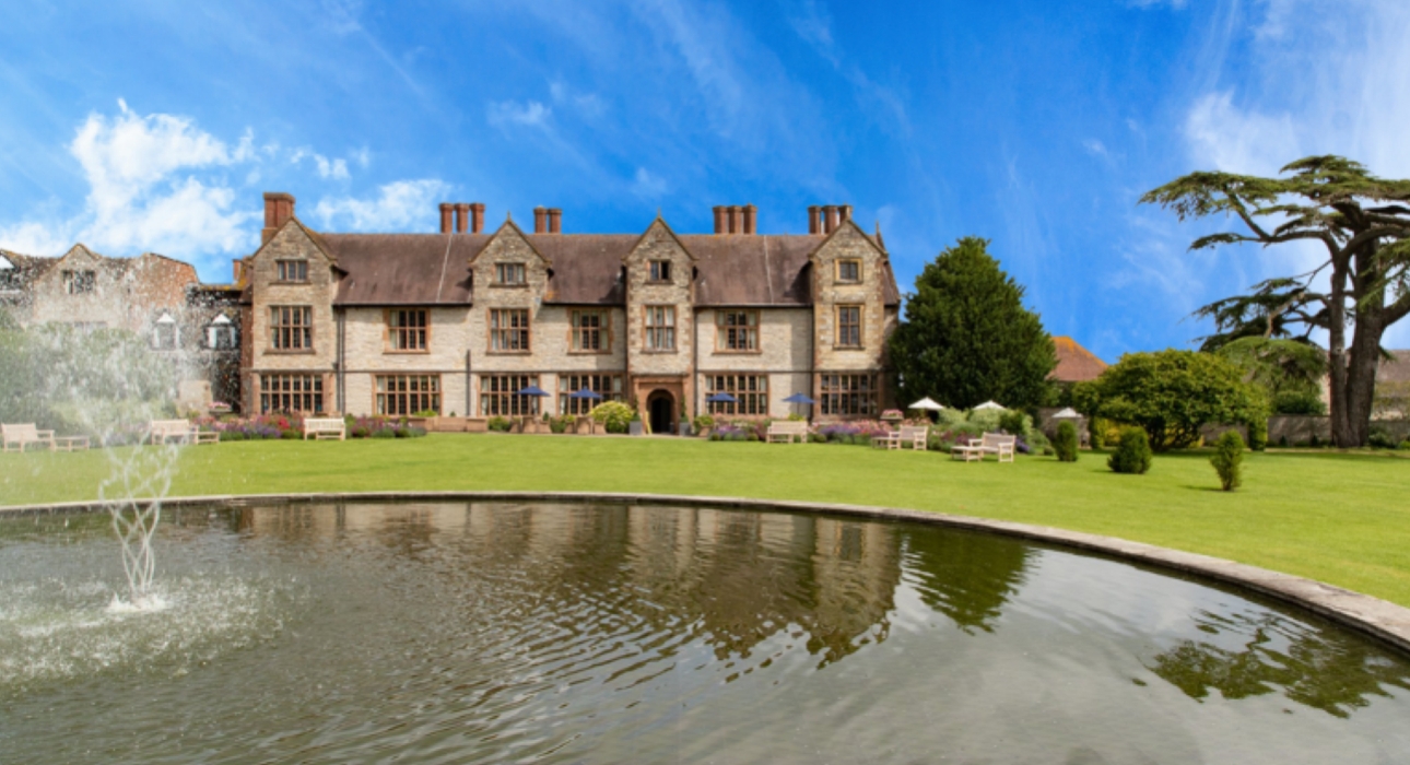 manor house with fountain in fore ground