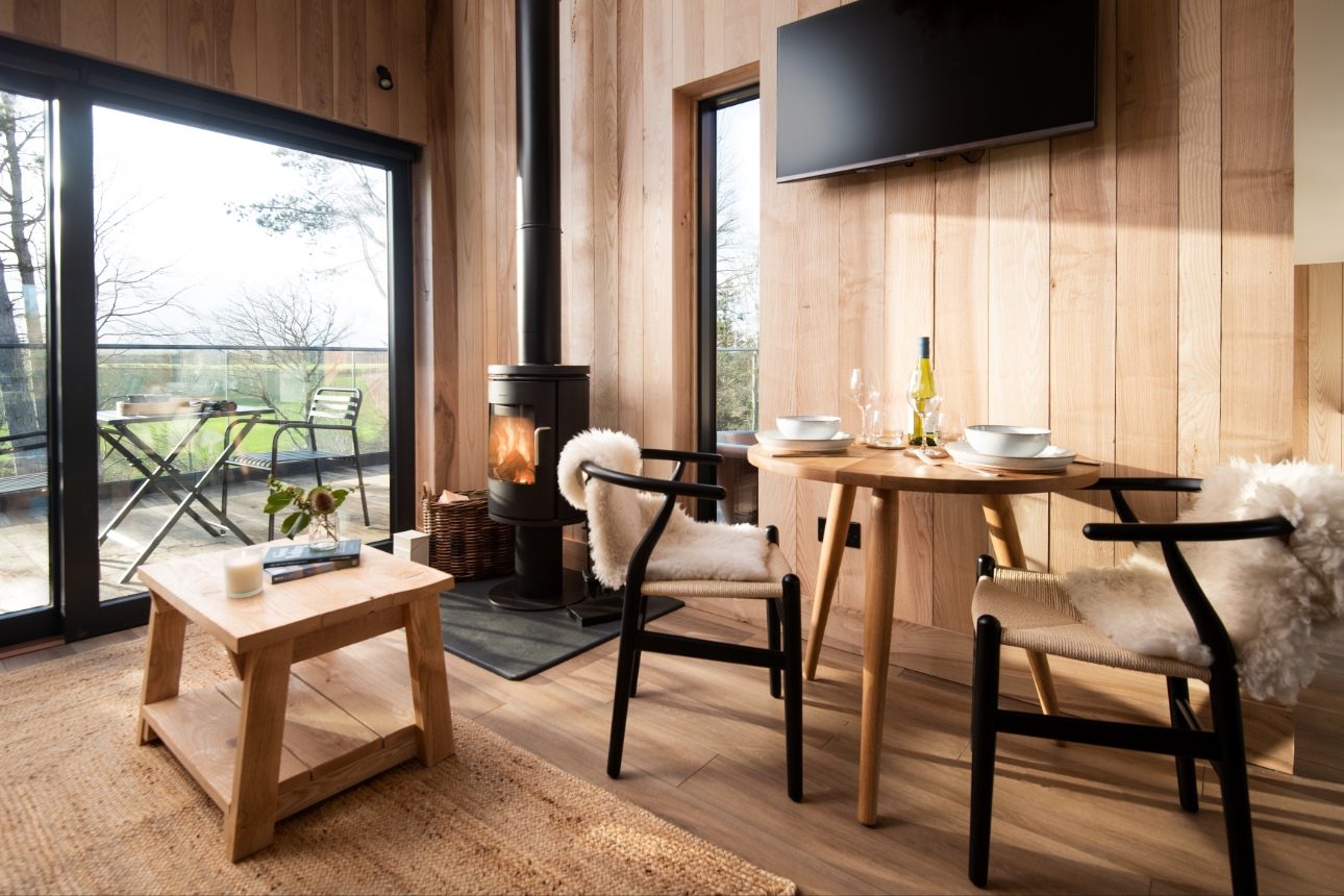 table set up, wood fire and TV inside a remote cabin 