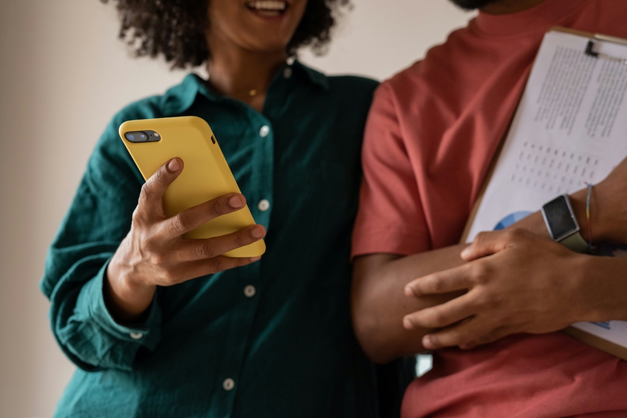 Couples holding clipboard and phone