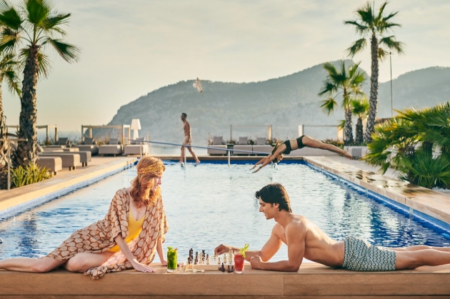 man and woman laying by pool