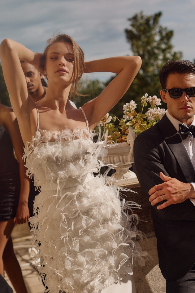 woman in white dress covered in feathers
