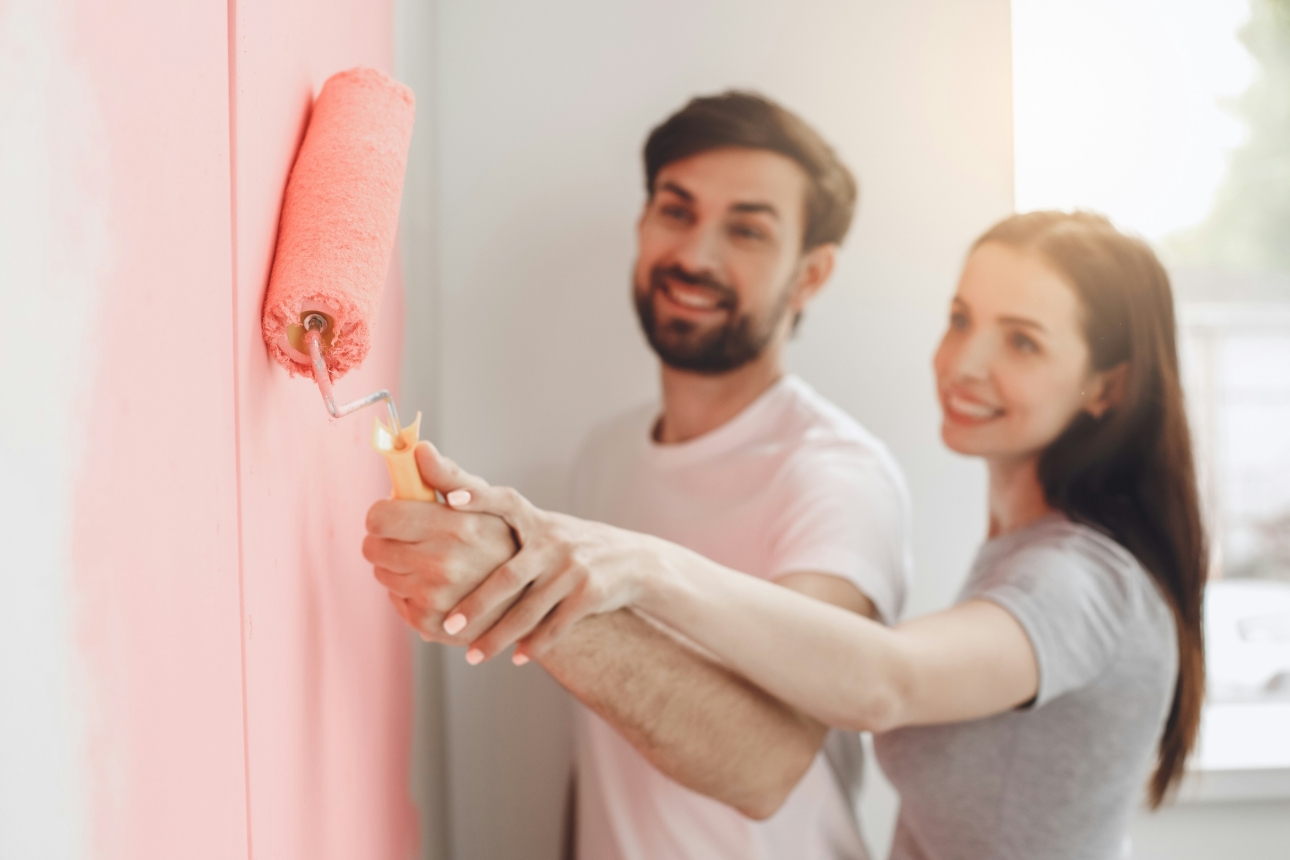 couple painting room pink
