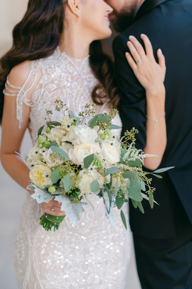 couple on wedding day bride holding bouquet
