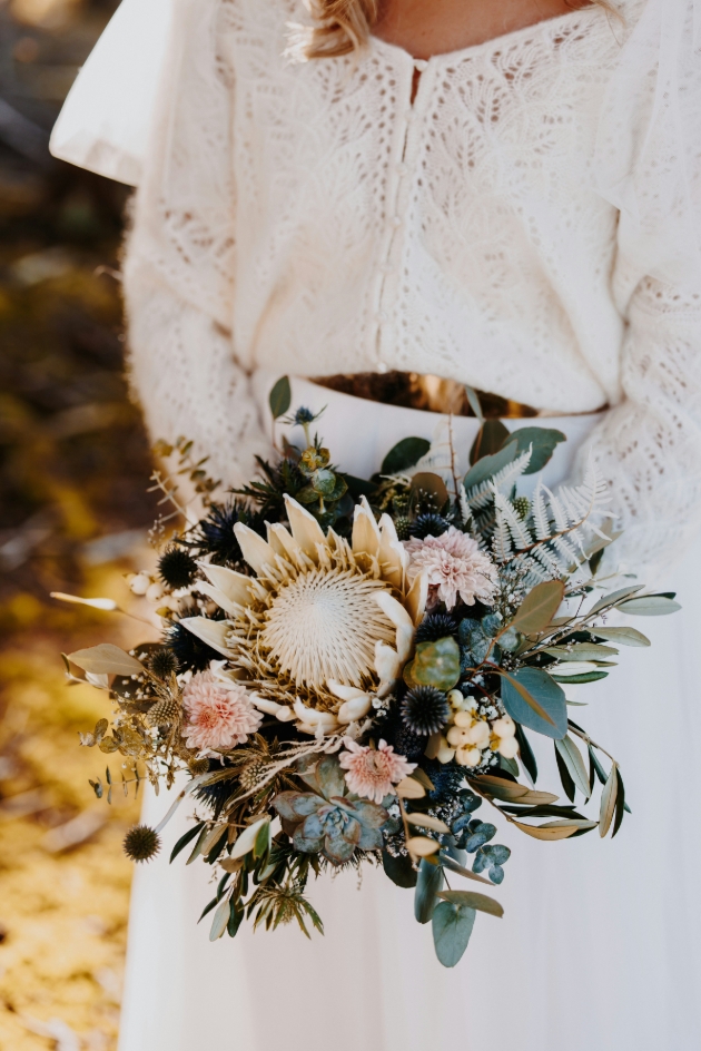 bride in white holding bouquet of flowers