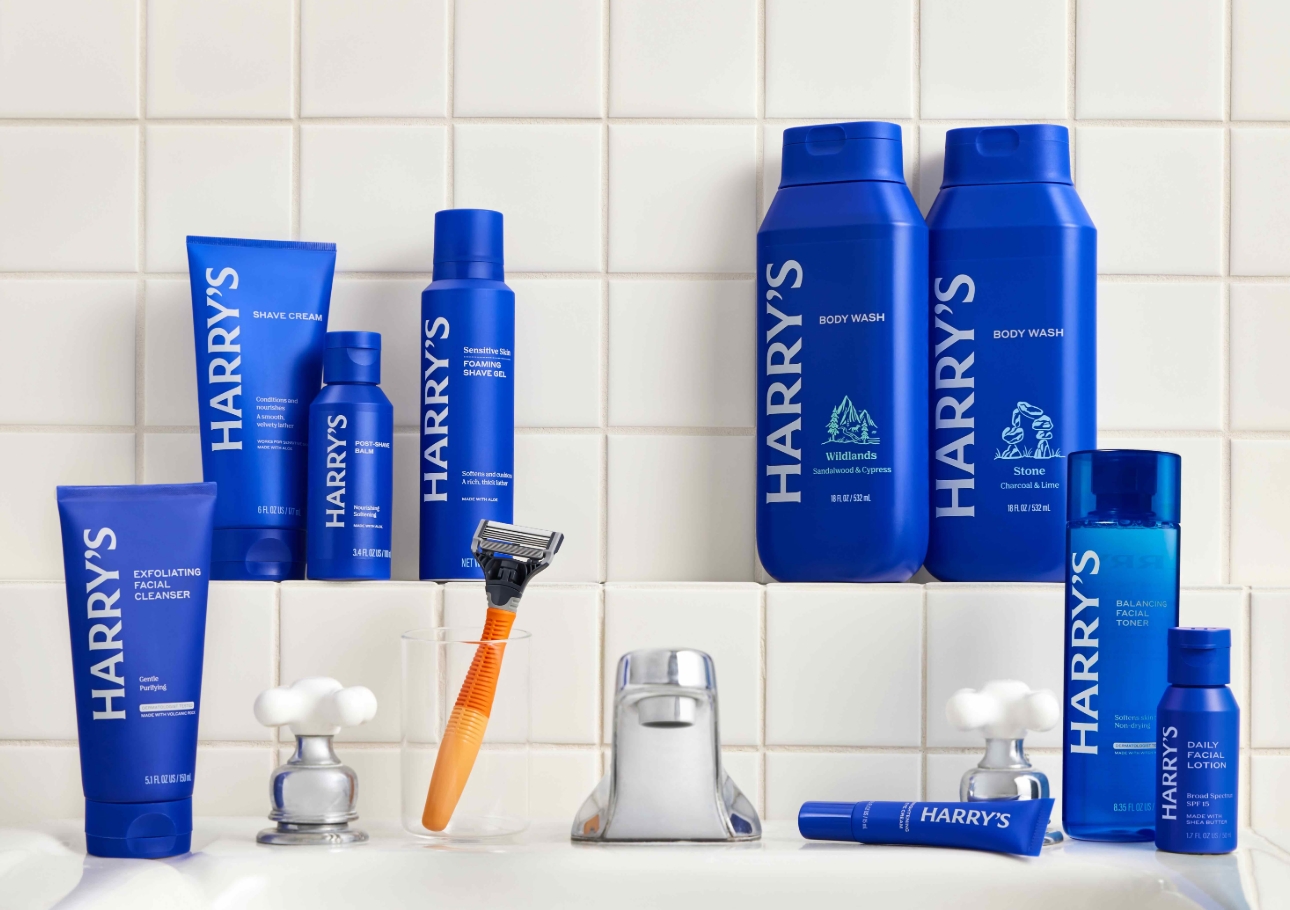 Collection of blue branded bottles on bathroom sink 