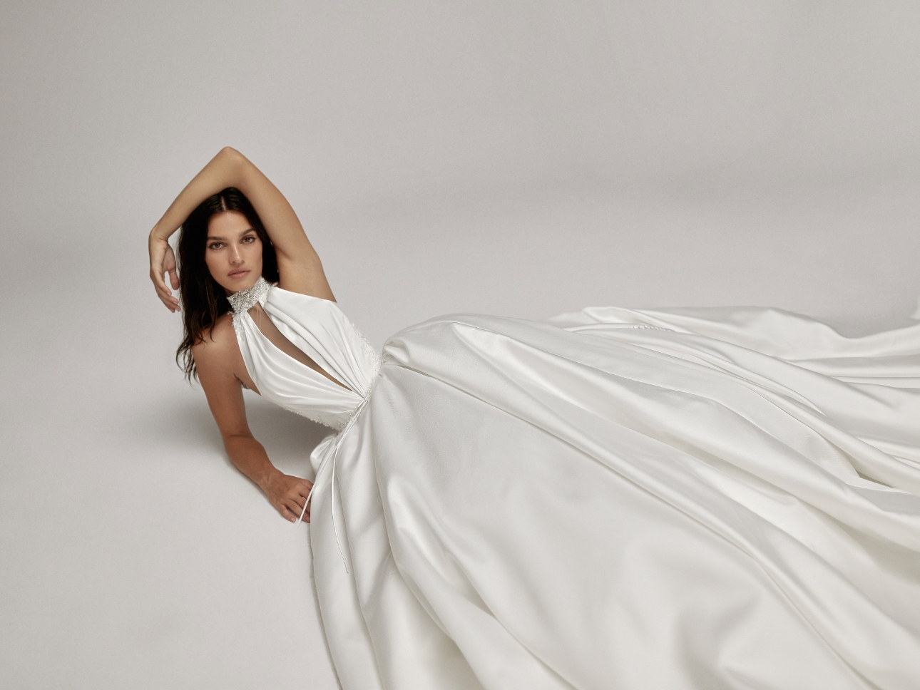 model laying down on floor in a wedding dress